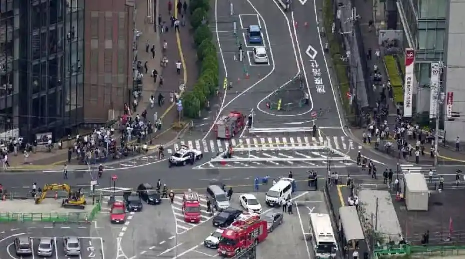 Tokyo intersection with emergency vehicles and pedestrians during incident. Channel i News - চ্যানেল আই নিউজ