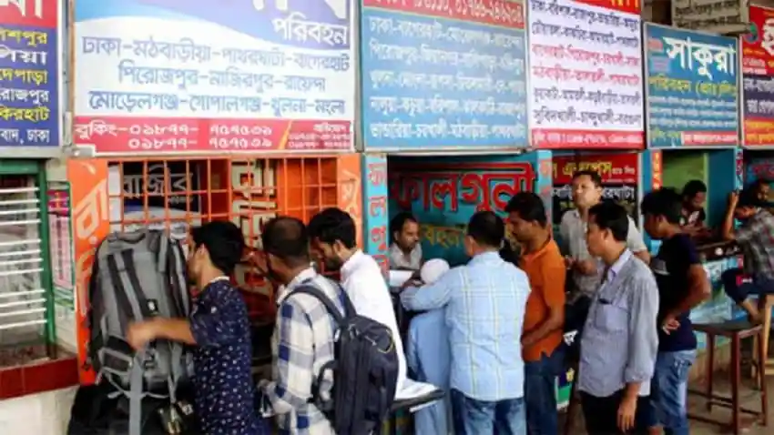 People buying bus tickets at a busy station in Bangladesh. Channel i News - চ্যানেল আই নিউজ