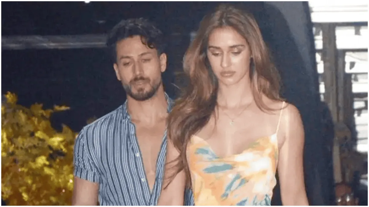 দুটি মানুষ একসঙ্গে হাঁটছেন, পেছনে অন্ধকার ও আলো ঝলমলে পরিবেশ।. Channel i News - চ্যানেল আই নিউজ