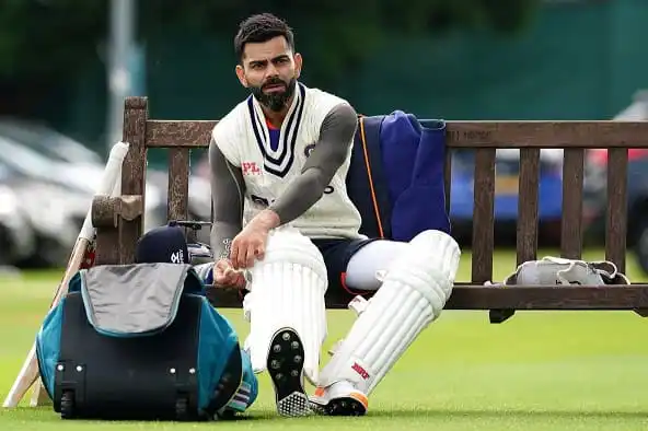 ক্রিকেটার বসে আছেন মাঠে, ব্যাট ও গ্লাভসের পাশে ব্যাগ রাখছেন. Channel i News - চ্যানেল আই নিউজ