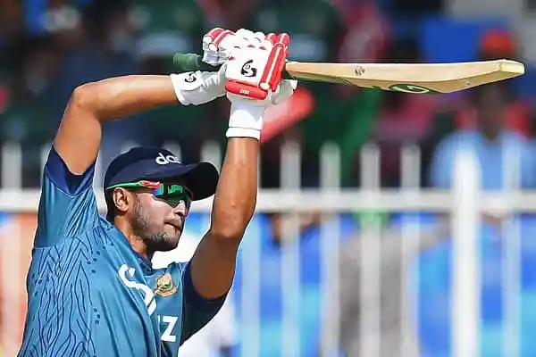 Bangladeshi cricketer celebrating with bat after scoring runs during match. Channel i News - চ্যানেল আই নিউজ