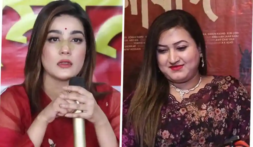 দুই নারী সংবাদ প্রতিবেদক, একজন মাইক্রোফোন ধরে কথা বলছেন. Channel i News - চ্যানেল আই নিউজ