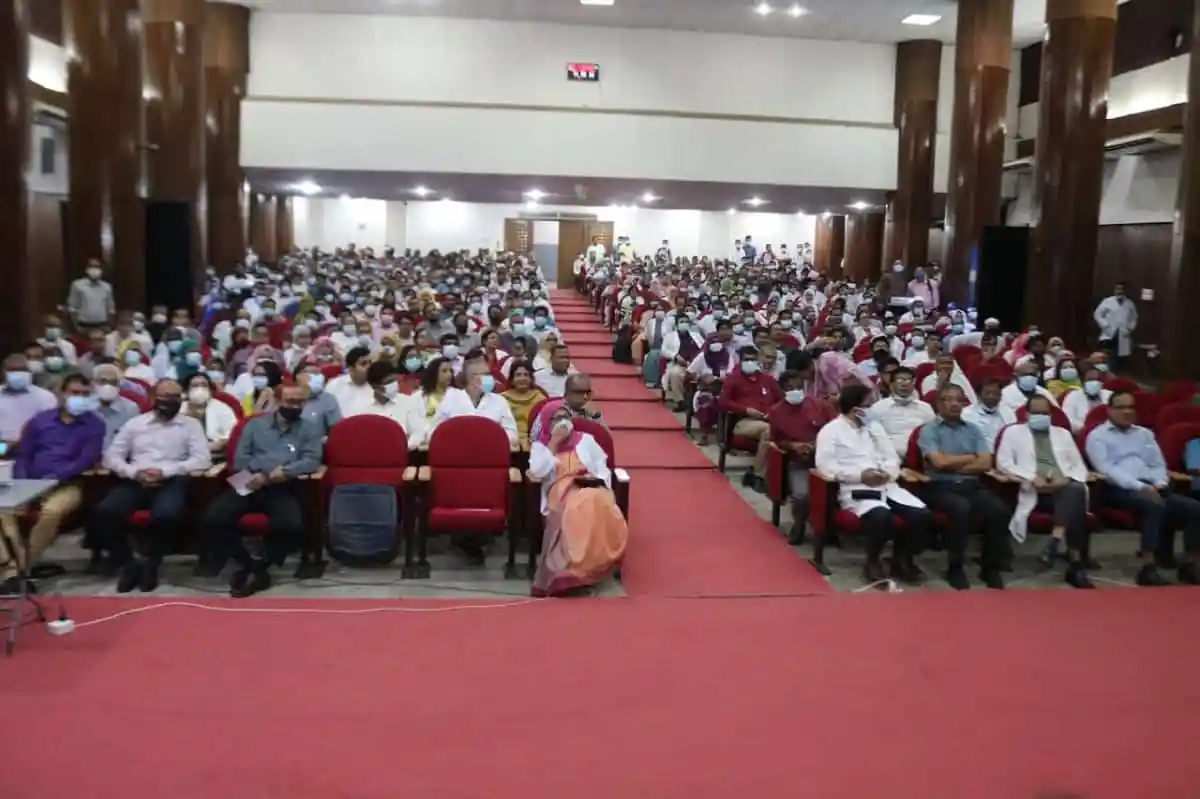 বৃহৎ সভা কক্ষে হাজারো দর্শক উপস্থিত, সামাজিক দূরত্ব বজায় রেখে বসে।. Channel i News - চ্যানেল আই নিউজ