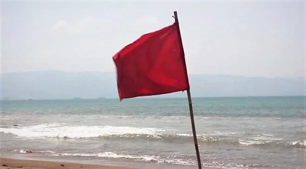 Red flag on the beach indicating caution or warning. Channel i News - চ্যানেল আই নিউজ