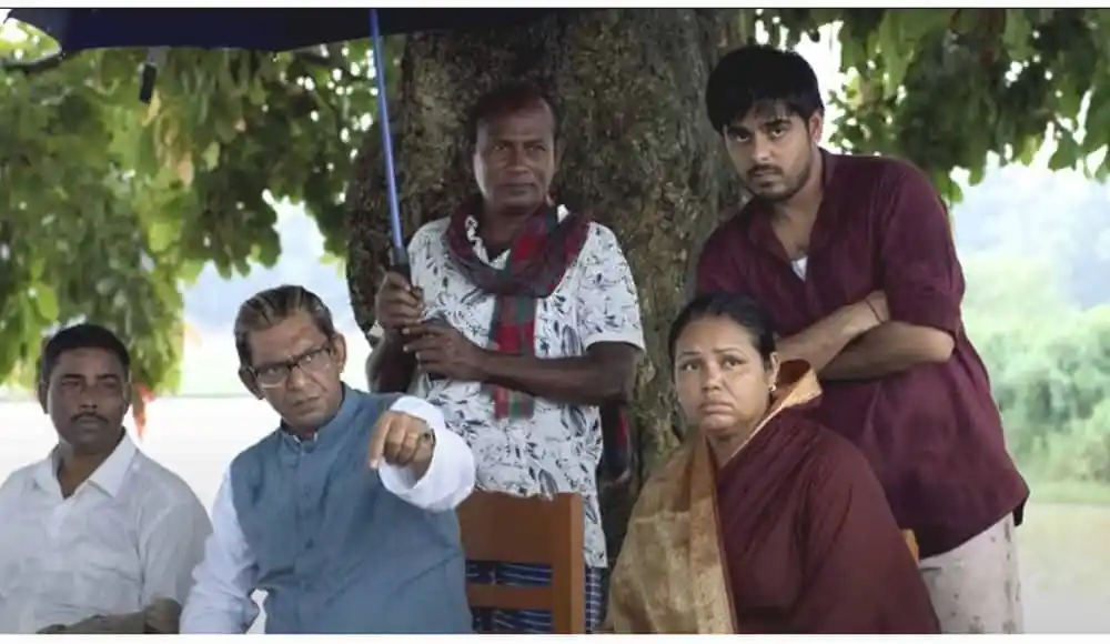 বাংলাদেশি ব্যক্তিরা একটি গাছের নিচে বসে আলোচনা করছে. Channel i News - চ্যানেল আই নিউজ