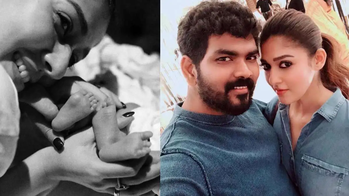 Black and white close-up of a woman holding a baby with a smile. Channel i News - চ্যানেল আই নিউজ