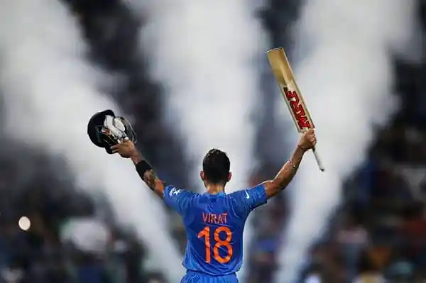 ভারতীয় ক্রিকেটার বিরাট কোহলি বিজয় পতাকা উড়িয়ে উদযাপন করছেন. Channel i News - চ্যানেল আই নিউজ