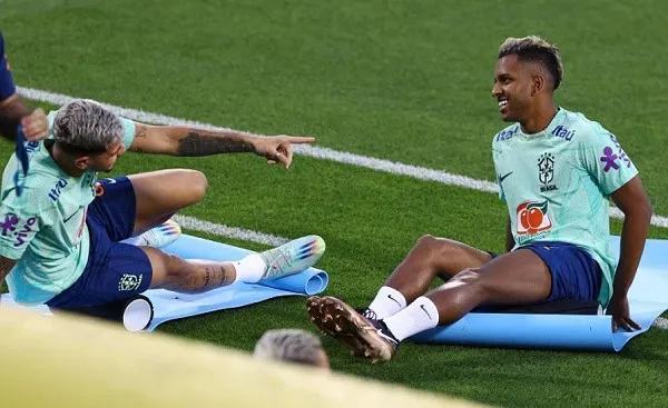 Brazilian footballers Rodrigo and Casemiro relaxing on the field after training. Channel i News - চ্যানেল আই নিউজ
