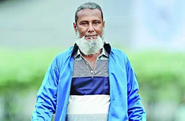 বৃদ্ধ পুরুষের ছবি, তিনি হালকা নীল জ্যাকেট পরেছেন।. Channel i News - চ্যানেল আই নিউজ