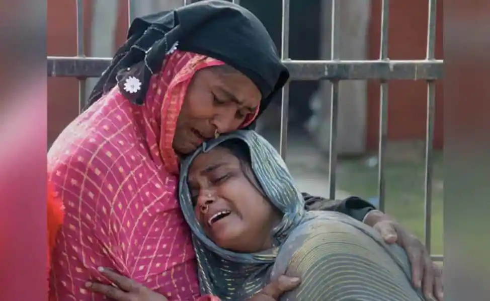 দুজন নারী কাঁদছেন, একে অপরকে জড়িয়ে ধরে।. Channel i News - চ্যানেল আই নিউজ