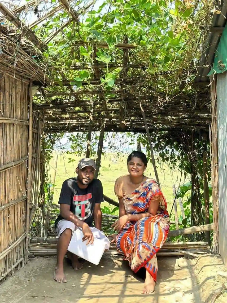 দুজন ব্যক্তি একটি গৃহের ভিতরে বসে আছেন, চারপাশে সবুজ গাছপালা।. Channel i News - চ্যানেল আই নিউজ