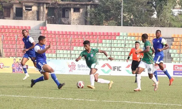 Bangladeshi youth football match with players in action on the field. Channel i News - চ্যানেল আই নিউজ