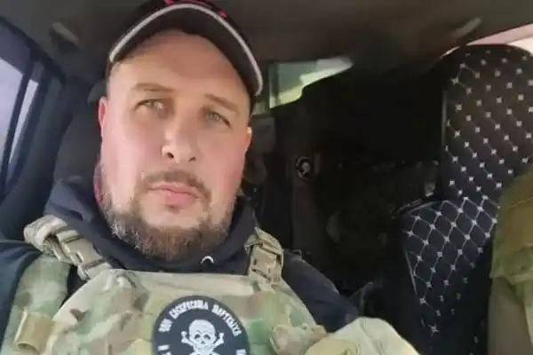 A man in military gear inside a vehicle, looking at the camera. Channel i News - চ্যানেল আই নিউজ