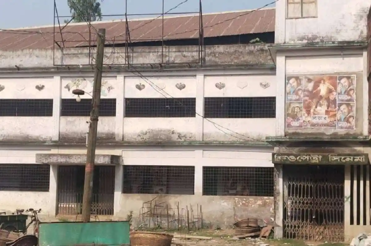 Old building with barred windows and faded posters in Bangladesh. Channel i News - চ্যানেল আই নিউজ