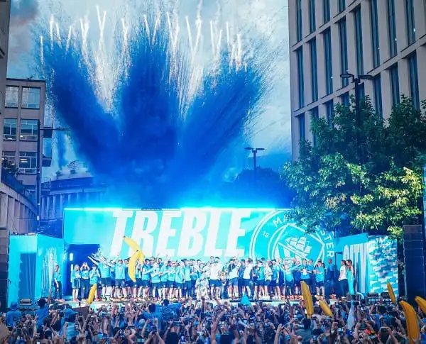 Manchester celebration with fireworks and large crowd during a sports event. Channel i News - চ্যানেল আই নিউজ
