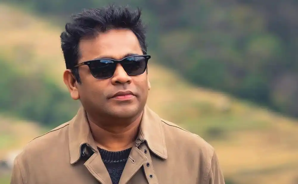 এ আর রহমান sunglasses পরা, প্রকৃতি পটভূমিতে দাঁড়ানো. Channel i News - চ্যানেল আই নিউজ