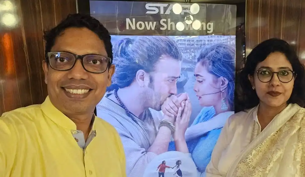 সিনেমা দেখার জন্য দুইজন দর্শক সিনেমা হলের সামনে দাঁড়িয়ে. Channel i News - চ্যানেল আই নিউজ
