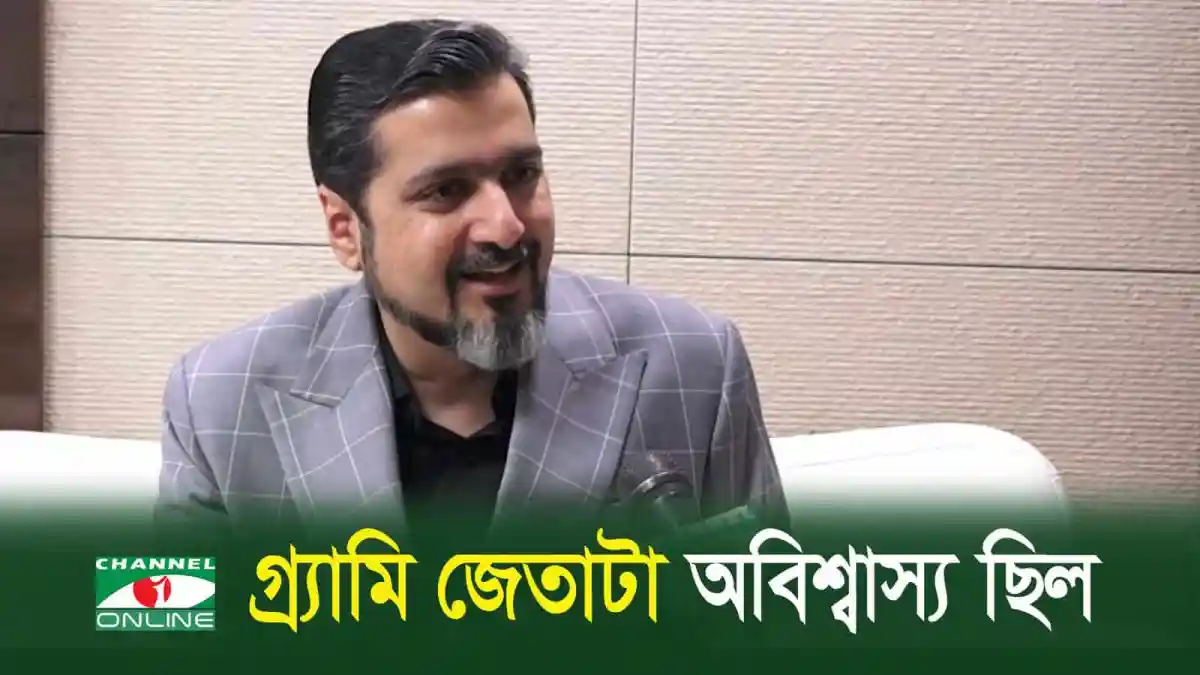 রিকি কেজের সাক্ষাৎকারে হাস্যোজ্জ্বল মুখ, পটভূমিতে বাংলা ভাষার সংবাদ শিরোনাম. Channel i News - চ্যানেল আই নিউজ
