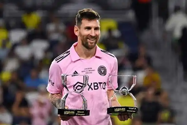 Lionel Messi holding two trophies after a football match. Channel i News - চ্যানেল আই নিউজ