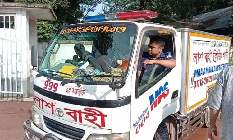 Bangladesh ambulance vehicle with medical staff inside, parked outdoors. Channel i News - চ্যানেল আই নিউজ