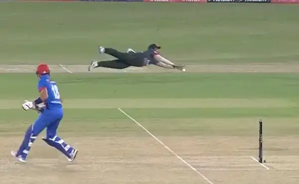 Cricket player diving to catch the ball on the field. Channel i News - চ্যানেল আই নিউজ