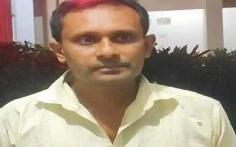 A man in a light-colored shirt standing outdoors at night. Channel i News - চ্যানেল আই নিউজ
