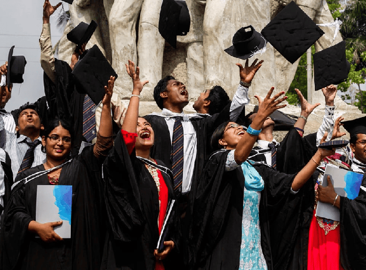 Graduates celebrating graduation outdoors with caps in air and smiles. Channel i News - চ্যানেল আই নিউজ