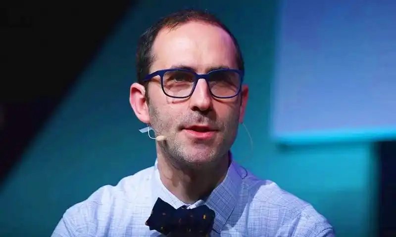 OpenAI's new CEO Emmet Shear at a conference or event. Channel i News - চ্যানেল আই নিউজ