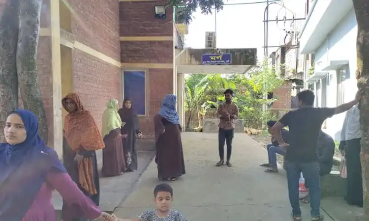 Bangladeshi people gather outside a building in a residential area. Channel i News - চ্যানেল আই নিউজ