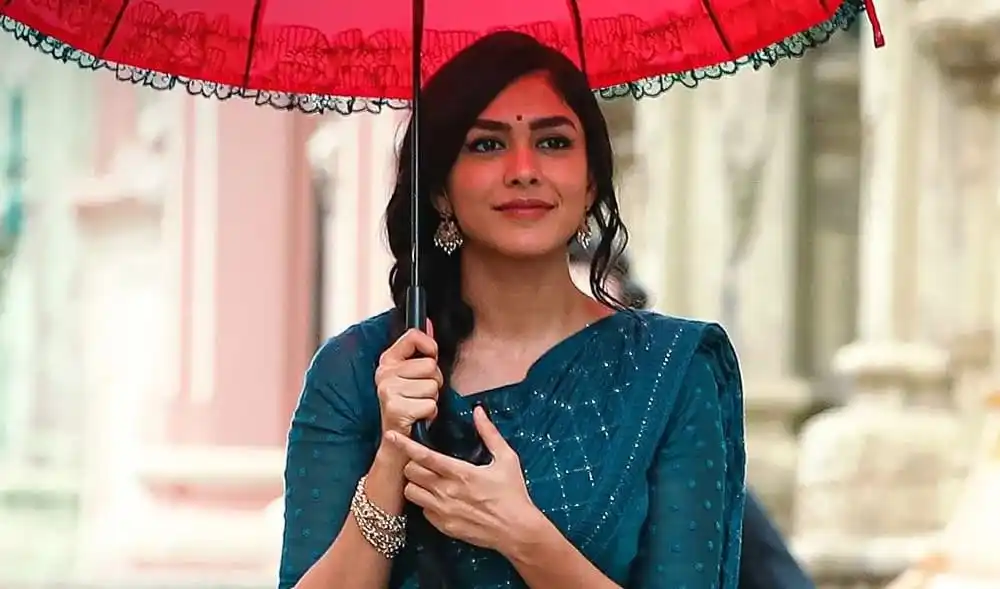 একজন নারী রঙিন ছাতা ধরে হাসিমুখে দাঁড়িয়ে. Channel i News - চ্যানেল আই নিউজ