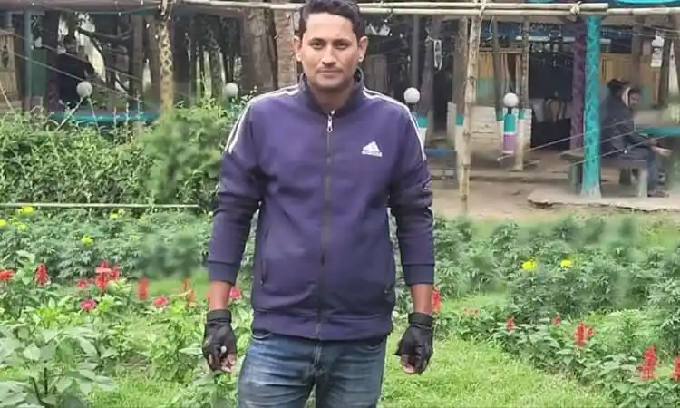 Young man standing in a garden with greenery and flowers. Channel i News - চ্যানেল আই নিউজ