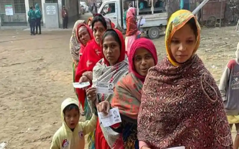 নওগাঁ-২ আসনে ভোটগ্রহণের জন্য ভোটাররা লাইনে দাঁড়িয়েছেন. Channel i News - চ্যানেল আই নিউজ