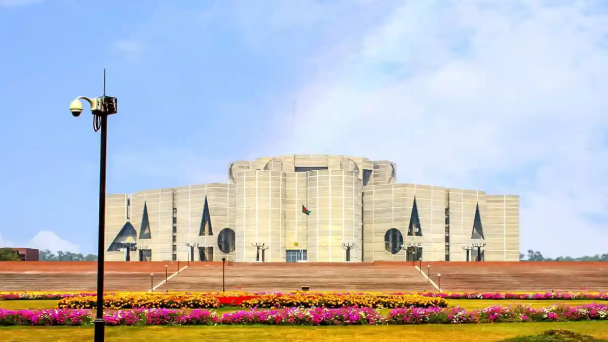 Parliament House in Dhaka, Bangladesh, under a blue sky. Channel i News - চ্যানেল আই নিউজ