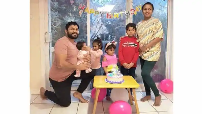 পরিবারের সদস্যরা জন্মদিনের কেকের সামনে হাসিমুখে ছবি তুলছে।. Channel i News - চ্যানেল আই নিউজ