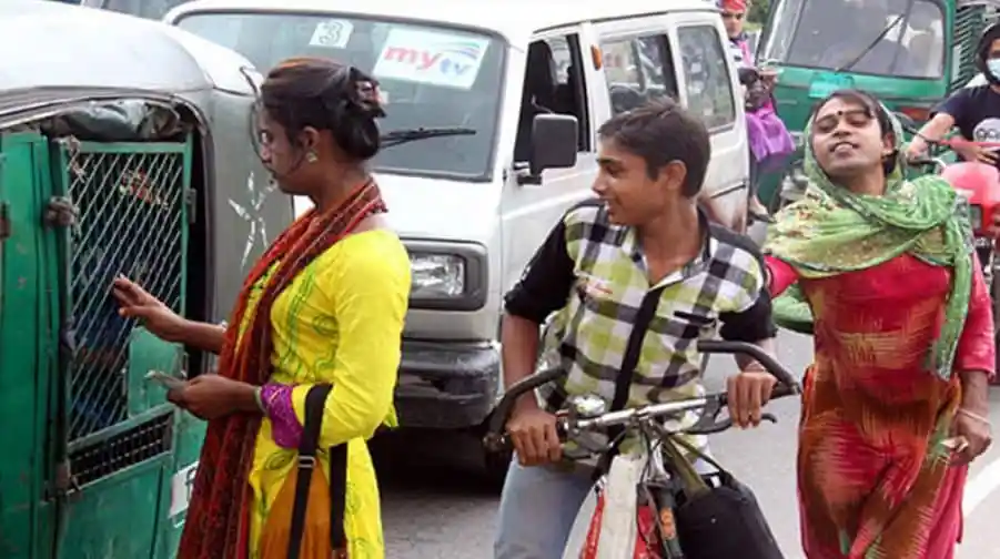 Bangladeshi women and children on busy city street with rickshaws and vehicles. Channel i News - চ্যানেল আই নিউজ