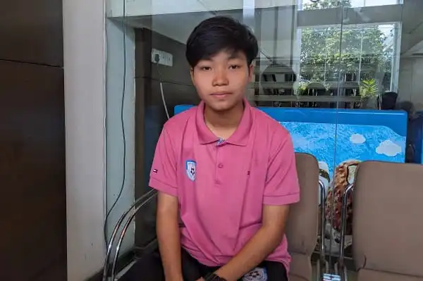 Young boy in pink polo shirt sitting indoors at Channel i Online. Channel i News - চ্যানেল আই নিউজ