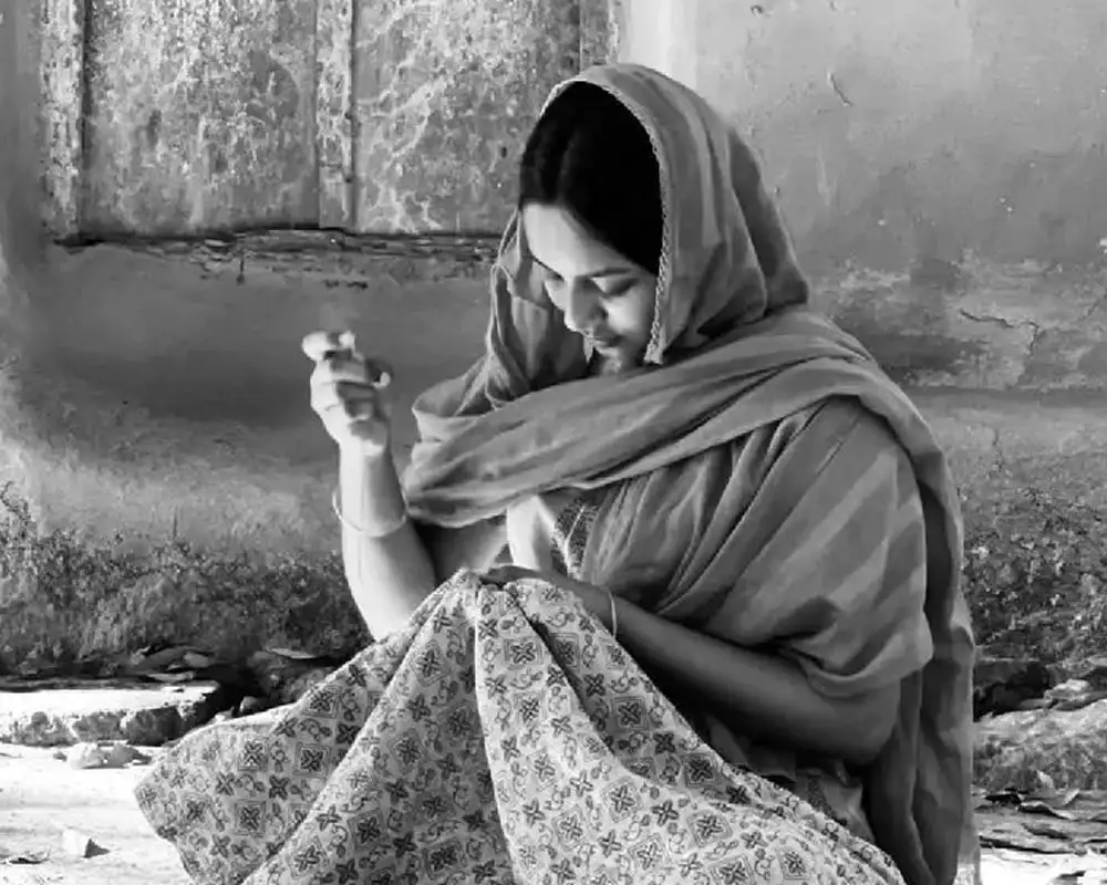 বাংলাদেশি নারী ছবি, ঐতিহ্যবাহী পোশাক পরা, পাথরের পাশে বসে. Channel i News - চ্যানেল আই নিউজ