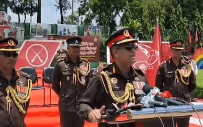 Bangladesh police officials at a public event with microphones and banners in the background. Channel i News - চ্যানেল আই নিউজ