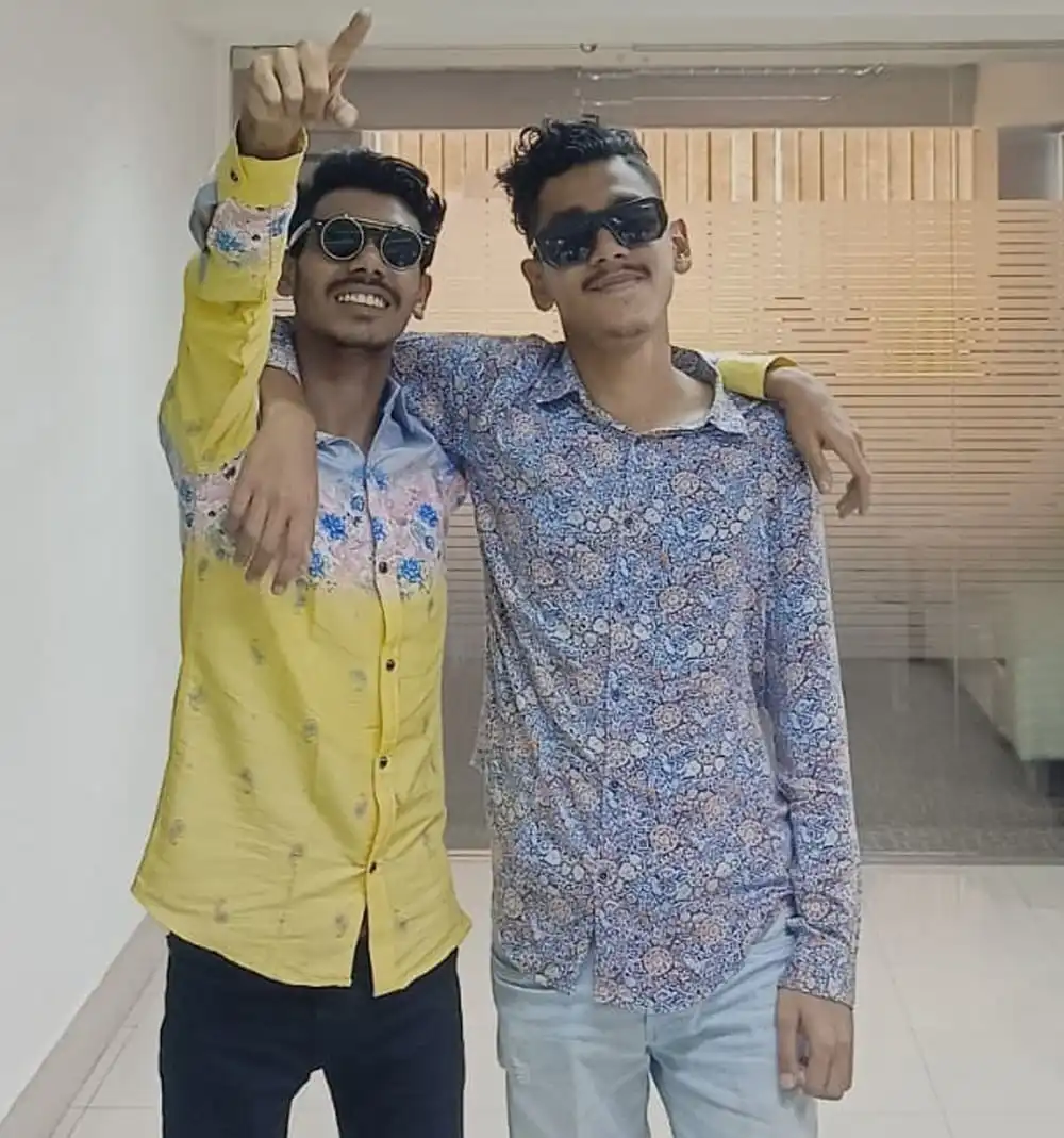 দুজন যুবক সানগ্লাস পরে হাসিমুখে ছবি তুলছেন. Channel i News - চ্যানেল আই নিউজ