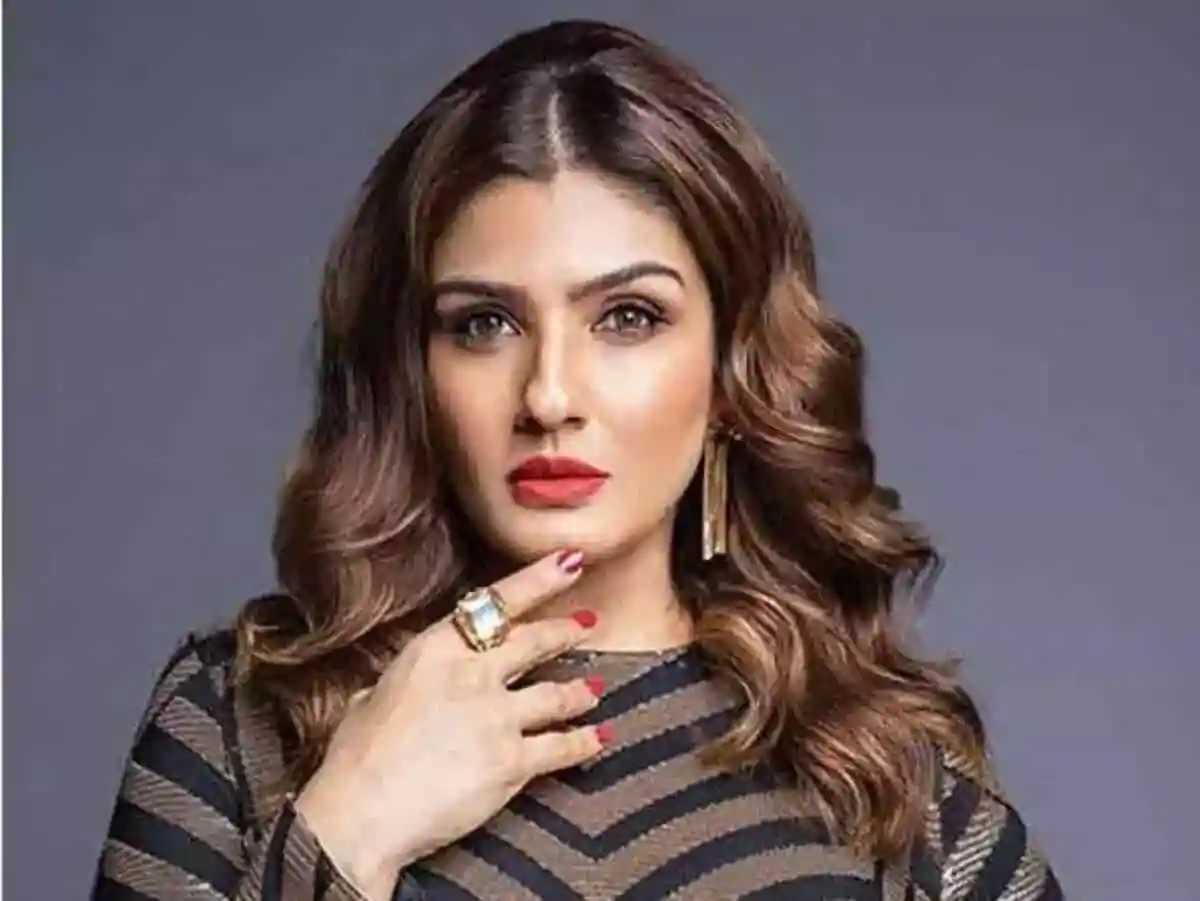 Stylish woman with wavy hair and bold makeup posing confidently. Channel i News - চ্যানেল আই নিউজ