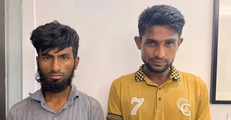 দুজন যুবক দাঁড়িয়ে আছেন, একটির পেছনে সাদা দেয়াল. Channel i News - চ্যানেল আই নিউজ