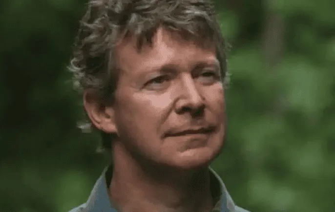 A man with curly hair looking thoughtfully into the distance. Channel i News - চ্যানেল আই নিউজ