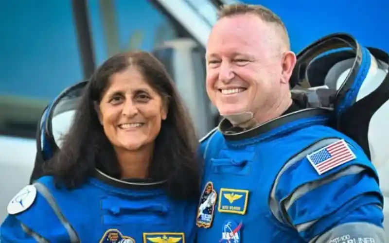 Two astronauts smiling in their space suits after space mission. Channel i News - চ্যানেল আই নিউজ