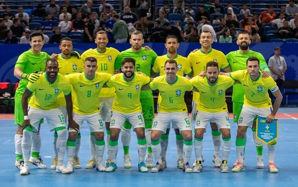 Brazil national futsal team in green and yellow jerseys posing for a team photo. Channel i News - চ্যানেল আই নিউজ