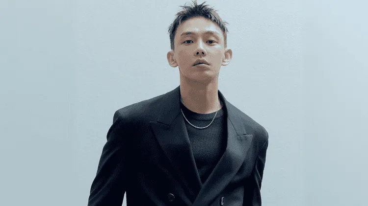Korean actor in black suit posing against plain background. Channel i News - চ্যানেল আই নিউজ