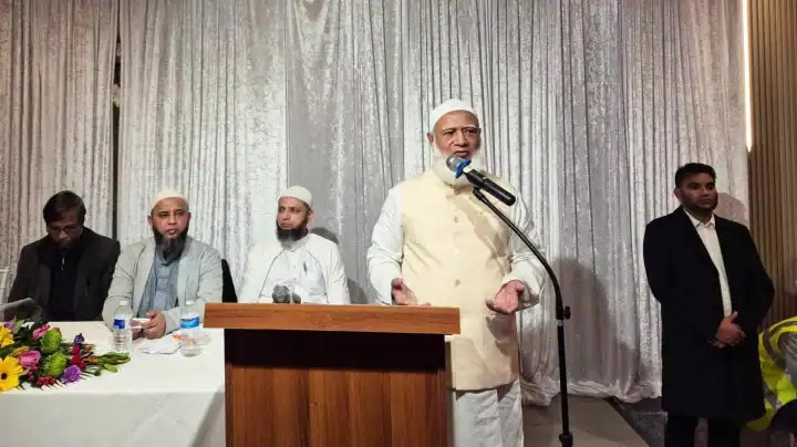 বাংলাদেশের একজন রাজনৈতিক নেতা বক্তৃতা দিচ্ছেন, পেছনে অন্য নেতারা উপস্থিত. Channel i News - চ্যানেল আই নিউজ