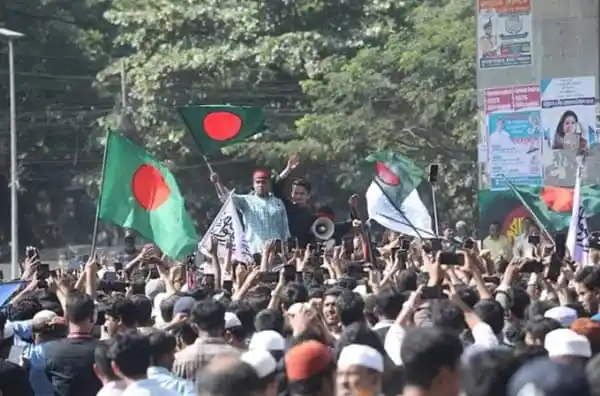 Bangladesh nationalists rally with flags and banners in a crowded street. Channel i News - চ্যানেল আই নিউজ