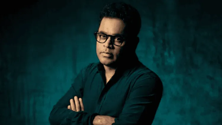 এ আর রহমানের ছবি, তিনি গ্লাসে চোখ রেখে পোজ দিচ্ছেন।. Channel i News - চ্যানেল আই নিউজ