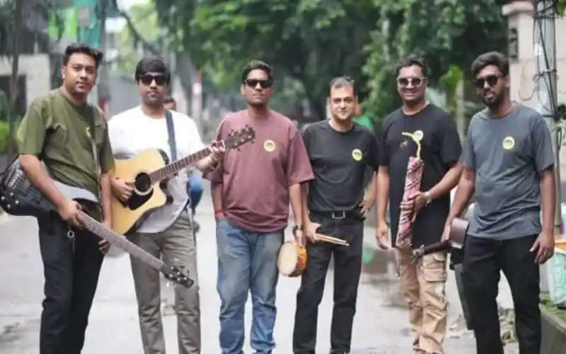 ব্যান্ড বায়োস্কোপের সদস্যরা রাস্তার পাশে গিটার ও ড্রাম নিয়ে দাঁড়িয়ে. Channel i News - চ্যানেল আই নিউজ
