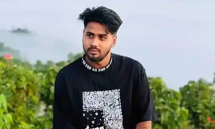 Young man with styled hair and beard outdoors in greenery. Channel i News - চ্যানেল আই নিউজ